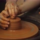 Closeup of Adult and Child's Dirty Hands Molding Clay Into Ceramic Pot - VideoHive Item for Sale