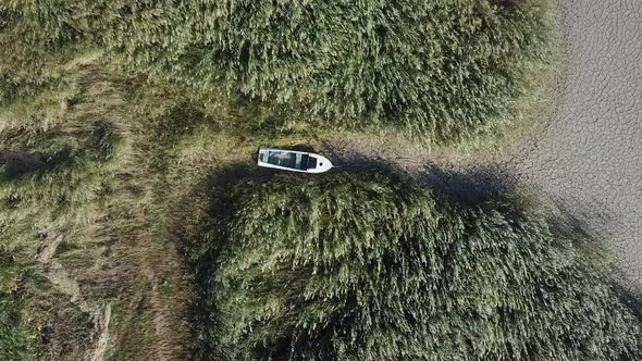 Top View of Abandoned Boat at the Shore of Dried Up Sea Global Warming and Drought Concept