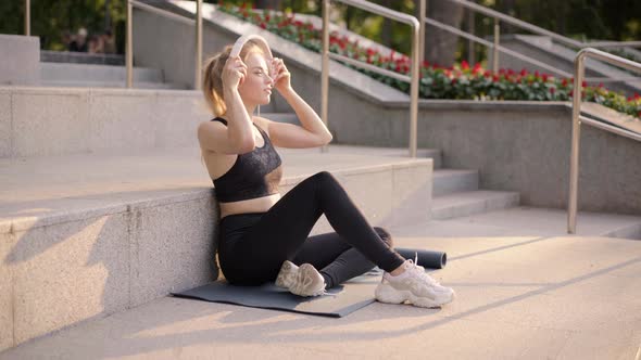 Sport and Fitness Young Adult Caucasian Woman Sitting Exercise Mat Concrete Floor Resting After