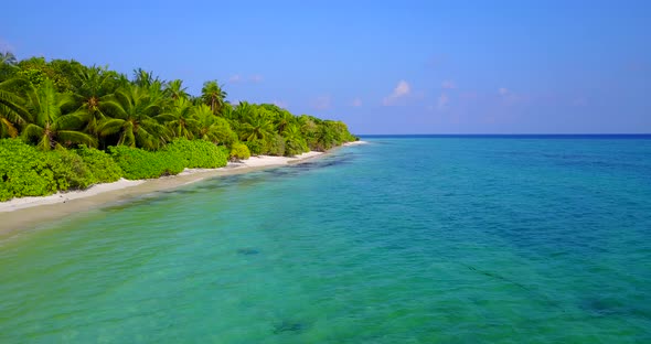 Wide drone tourism shot of a white paradise beach and aqua turquoise water background in vibrant 4K