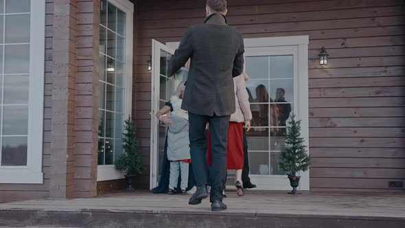 Family with Kids Comes in the House of Grandparents to Celebrate Christmas