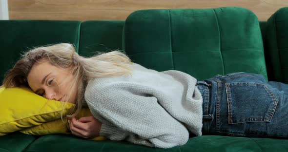 Bored Young Sleepy Woman Falls Down on Sofa