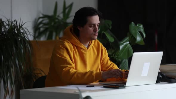 Man working at home office at laptop