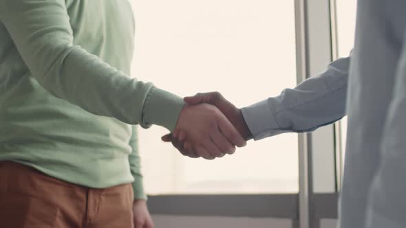 Unrecognizable Men Shaking Hands