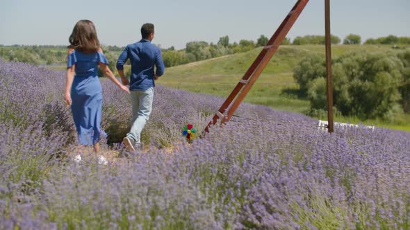 Joyful Multethnic Couple Running in Lavender Field