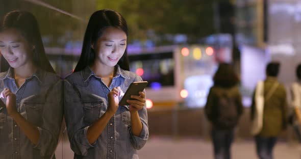 Woman Looking at Mobile Phone in City 