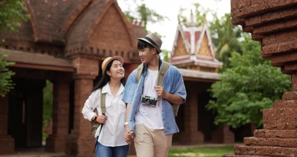 Couple hand together while visiting at ancient temple