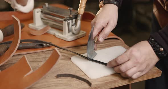 Master Making Leather Belt in a Workshop