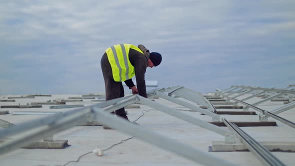 Man installing alternative energy. Worker installing solar panels outdoors
