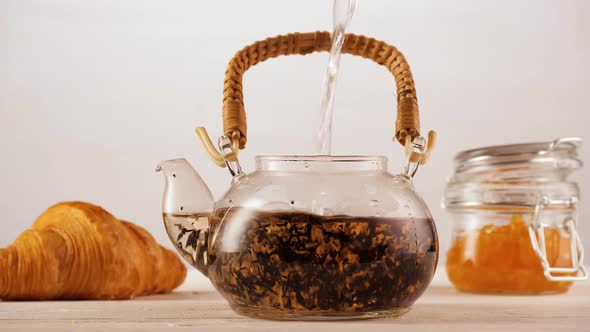 Anonymous Person Pouring Water Into Teapot