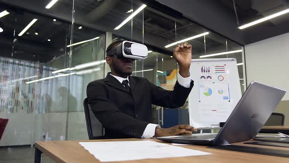 African American Male Manager which Gesturing Hands Using Virtual Reality Headset