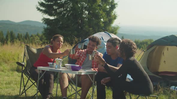 Cheerful Diverse Multicultural Backpackers Celebrating Successful Mountain Hiking at Camping