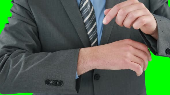 Mid section of businessman pretending to use smart watch
