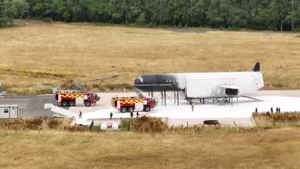 Firefighters Training to Tackle a Fire of a Dummy Aircraft