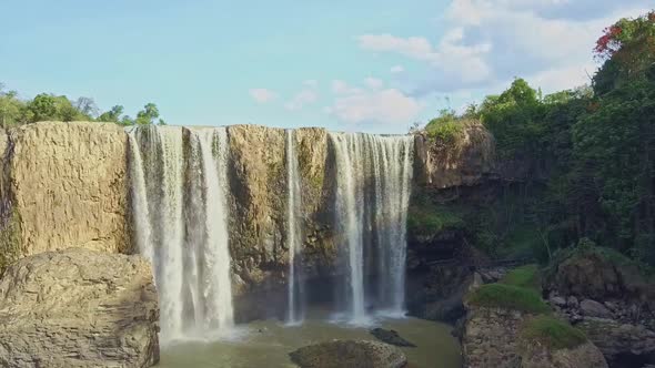 Drone Approaches Close Powerful Water Streams Down Rocky Wall