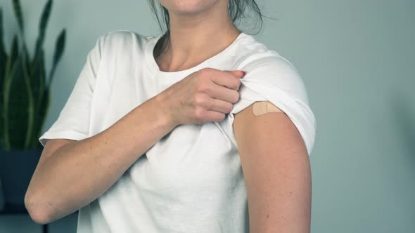 Cheerful Vaccinated Woman Pointing at Arm After Vaccine Injection