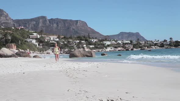 Young woman jogging on beach