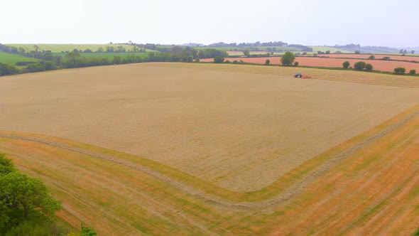 Heavy agriculture machine tractor ploughing the field 4k