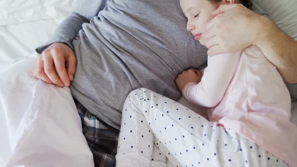 Father and daughter peacefully sleeping together