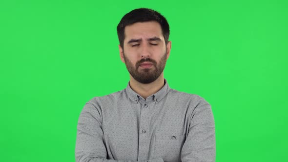 Portrait of Brunette Guy Is Listening To Information, Shocked and Very Upset . Green Screen