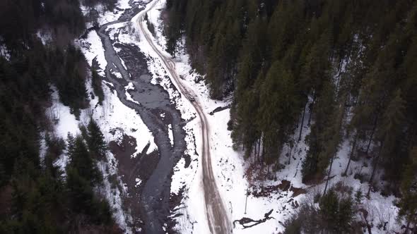 Drone top view SUV driving on a mountain road. winter. panorama.