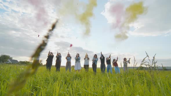 Cheerful Girls Shoot Colorful Powder From Pneumatic Clappers