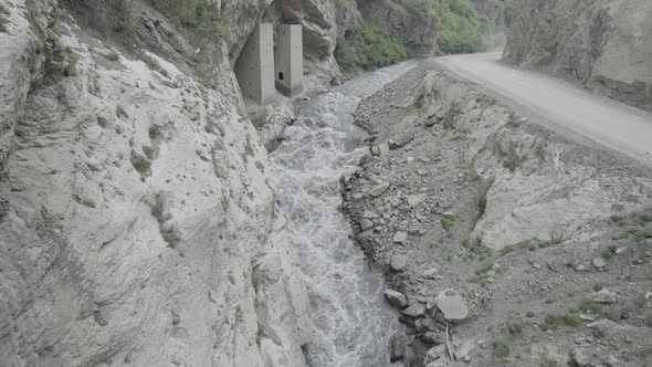 A Powerful Stream of Water is Squeezed Between the Sides of the Rocks