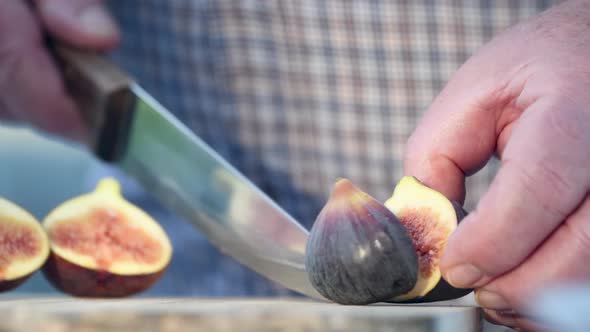 Man Cutting Slices of Deliciuos Figs Outdoor