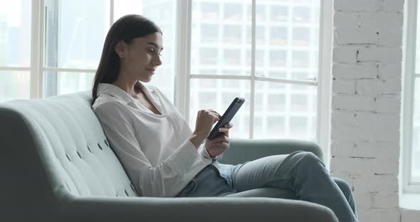 Smiling Young Woman Enjoying Using Smartphone Application Reading Positive News