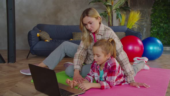 Mother and Daughter Choosing Fitness Tutorial Online
