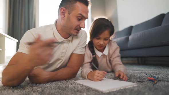 Father and Daughter Communicate, Having Fun and Painting Together. Concept of a Happy Family and