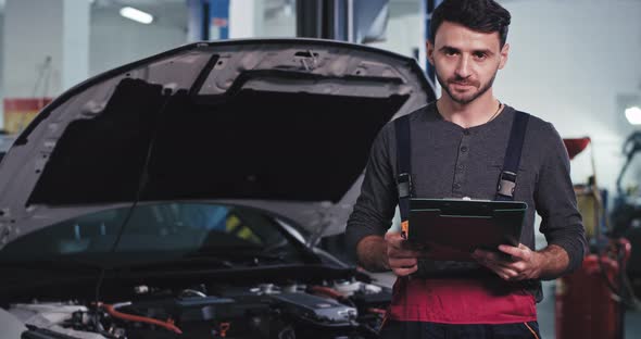 Perfect Looking Guy Mechanic Holding a Map with