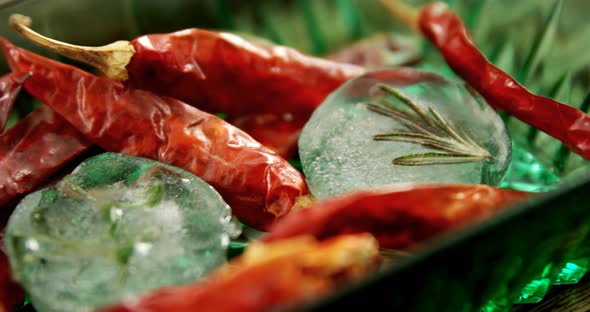 Flavored ice cubes with herb and dried red chili pepper 4k