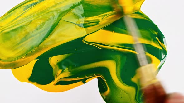 Artist Mixing Ingredients Green and Yellow Watercolor Using Palette Knife and Pigments on White