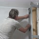 A Man Tries on a Plastic Corner When Installing PVC Panels in Bathroom - VideoHive Item for Sale