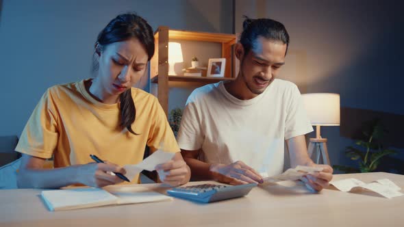 asia man and woman use calculator for calculate family budget debts monthly expenses.