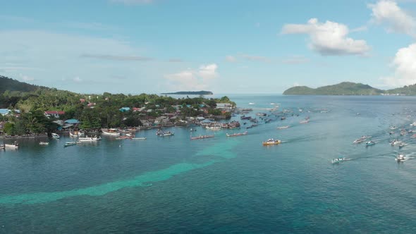 Aerial: kora-kora traditional canoe annual race in Banda Neira Indonesia