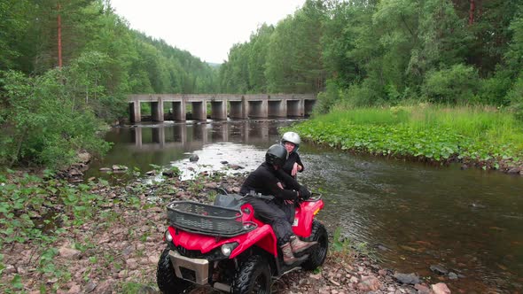 Aerial of Happy Couple on Quad Bike Relaxing