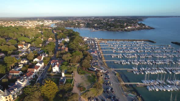 4K Aerial Video of a City by the Sea with View of Canals, Boats, Beach.