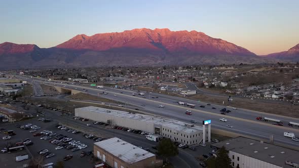 Aerial view of traffic moving on highway at sunset