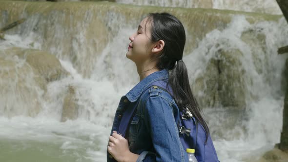 Asian Woman Hiker Enjoying At Waterfall