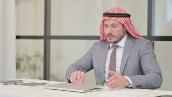 Middle Aged Arab Businessman Closing Laptop Standing Up, Going Away