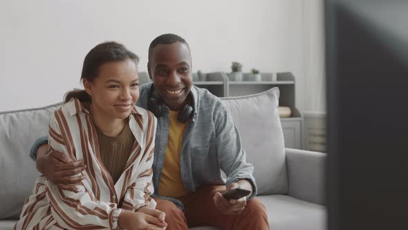 Young Couple Watching TV and Talking
