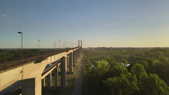 Dolly in flying alongside Zarate Brazo Largo road and railway complex cable-stayed bridge between gr