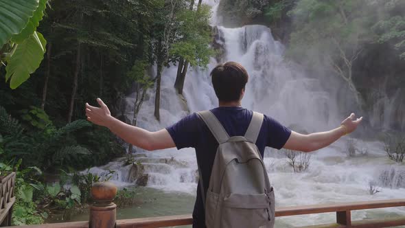 Asian Man Enjoy With Waterfall