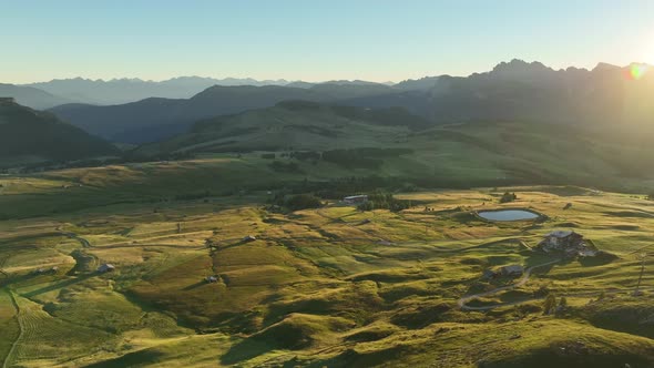 Dolomites mountains peaks with a hiking path on a summer sunrise