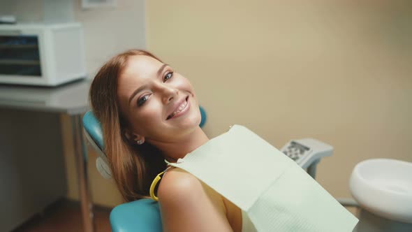 Happy Smile of Girl with Orthodontic Braces in Dental Chair