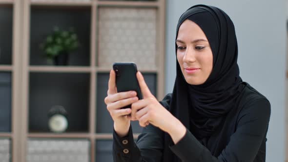 Closeup Happy Muslim Woman in Black Headscarf Chatting Surfing Internet Use Smartphone at Home