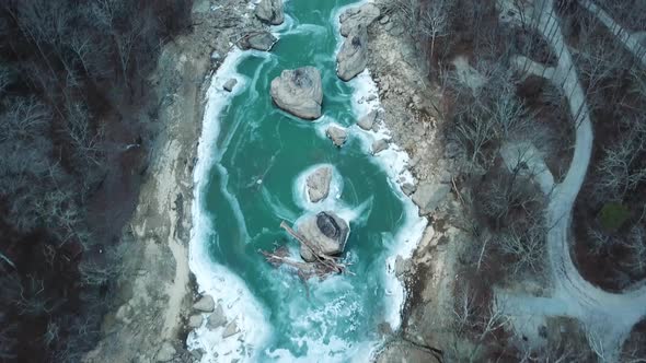 Driftwood and Boulders in an Iced Over Mountain River