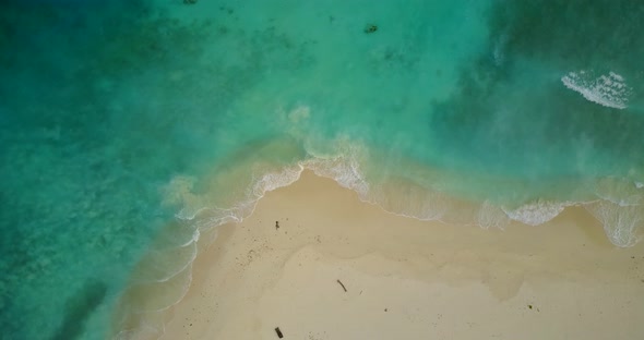 Beautiful overhead abstract shot of a white sand paradise beach and blue sea background in high reso